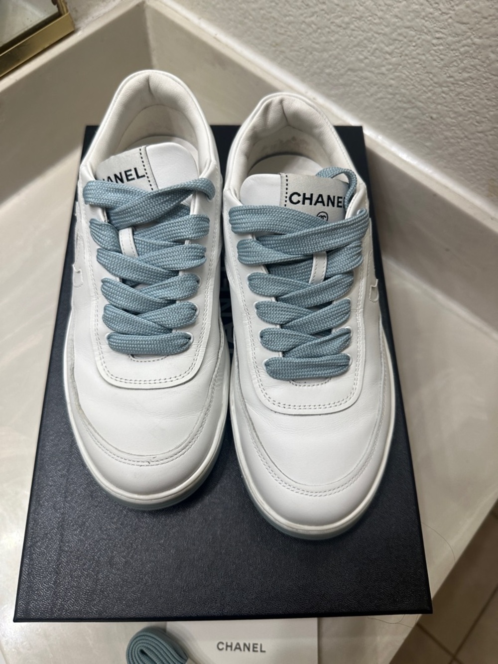 Authentic CHANEL White Leather Women’sSneakers with Light Blue trim.